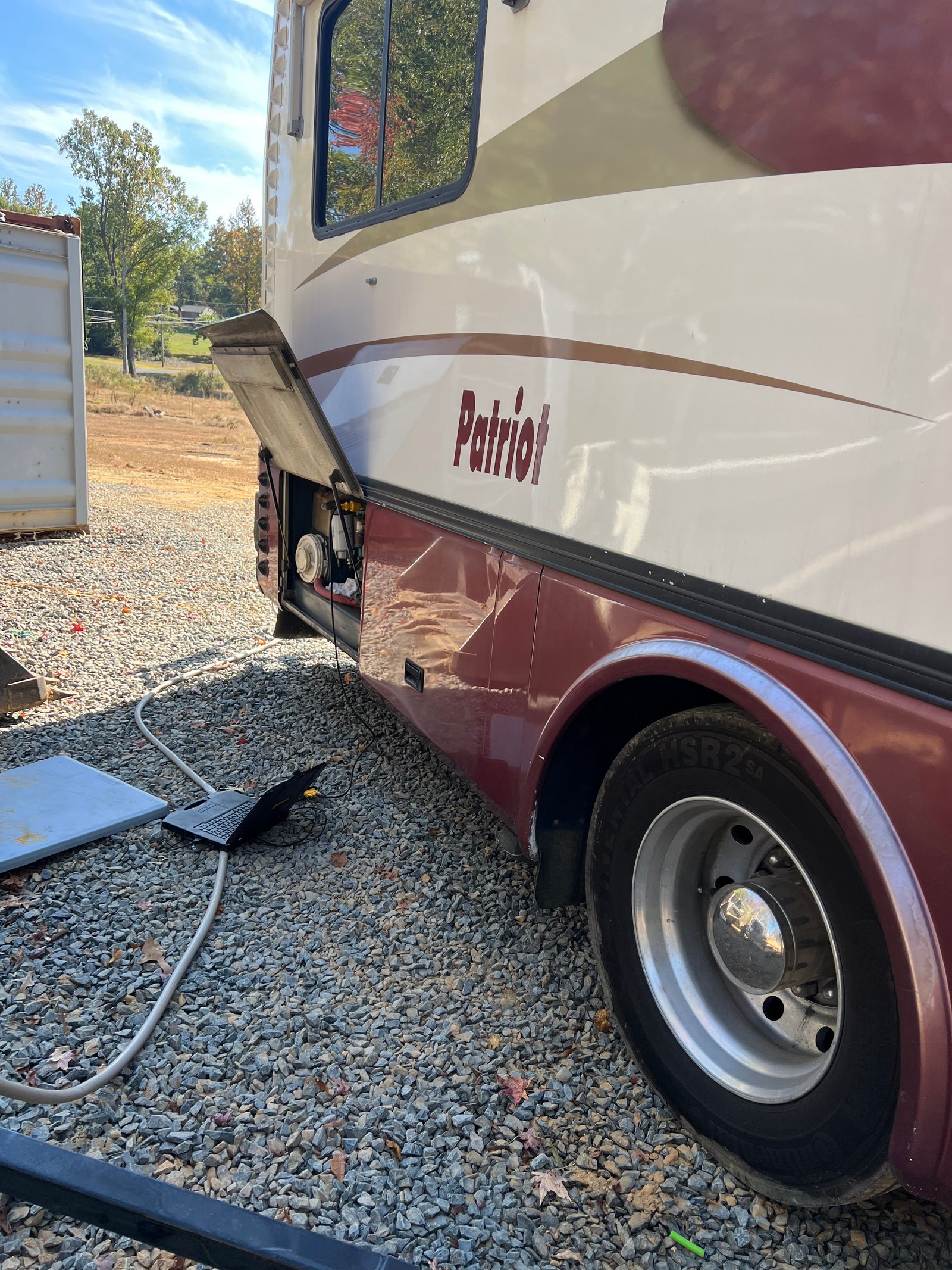 Patriot badge and open engine compartment on the 1997 Beaver motorhome during diesel repair