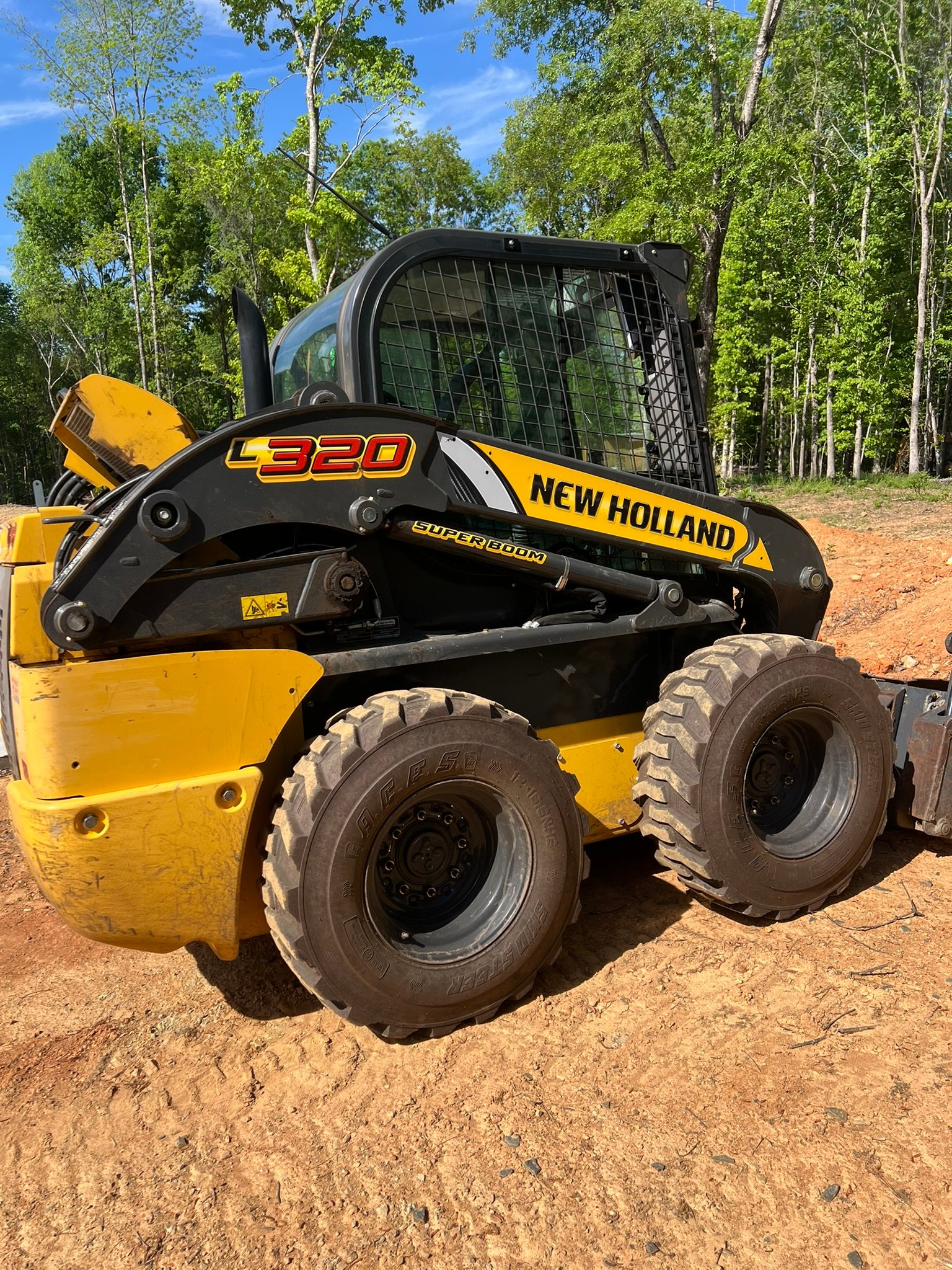 New Holland skid steer loader (L320) in yellow and black