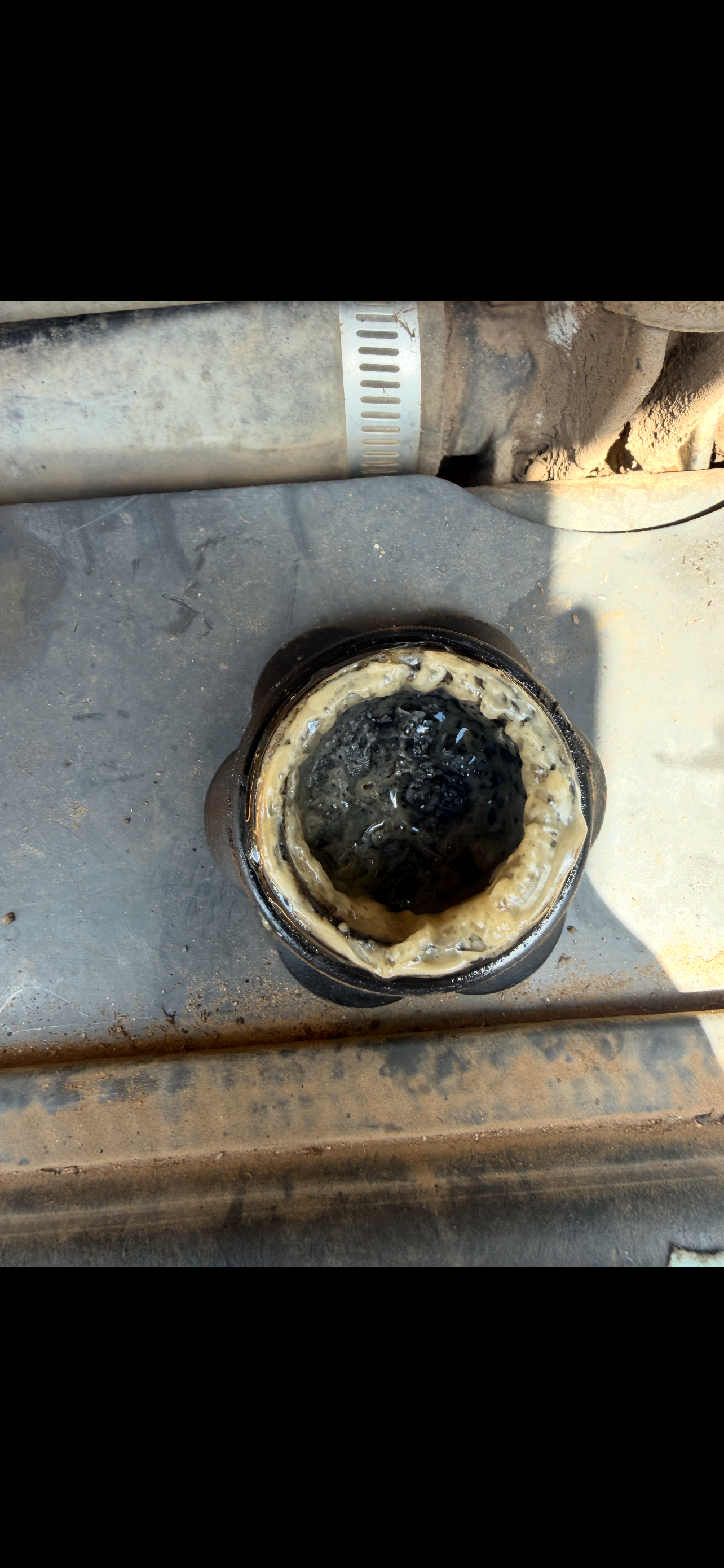 Radiator neck on a New Holland skid steer with oil and coolant emulsion in the cooling system