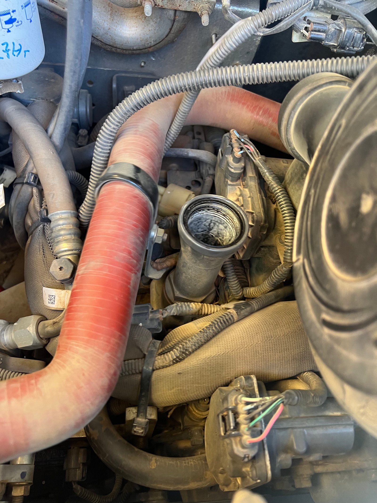 Engine bay of a New Holland L320 during engine oil cooler replacement at Maples Diesel in Albemarle