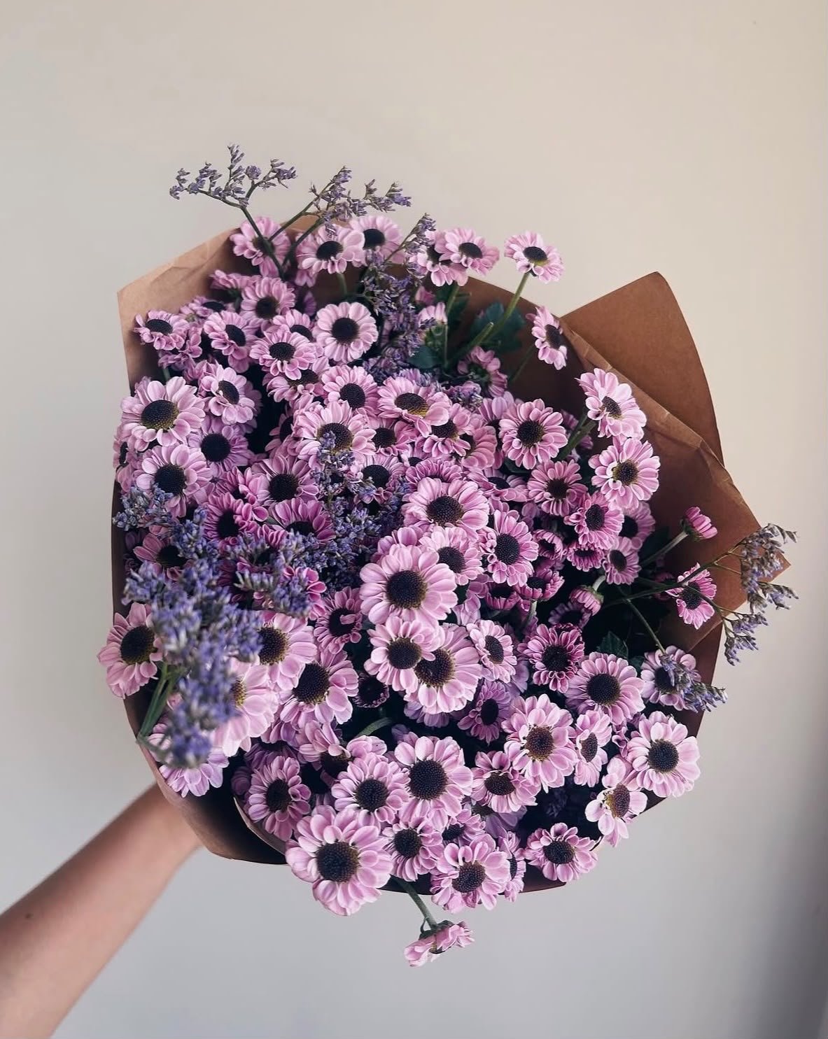 Fresh flower bunch in Calicut by CHLORIS — purple daisies wrapped in kraft paper