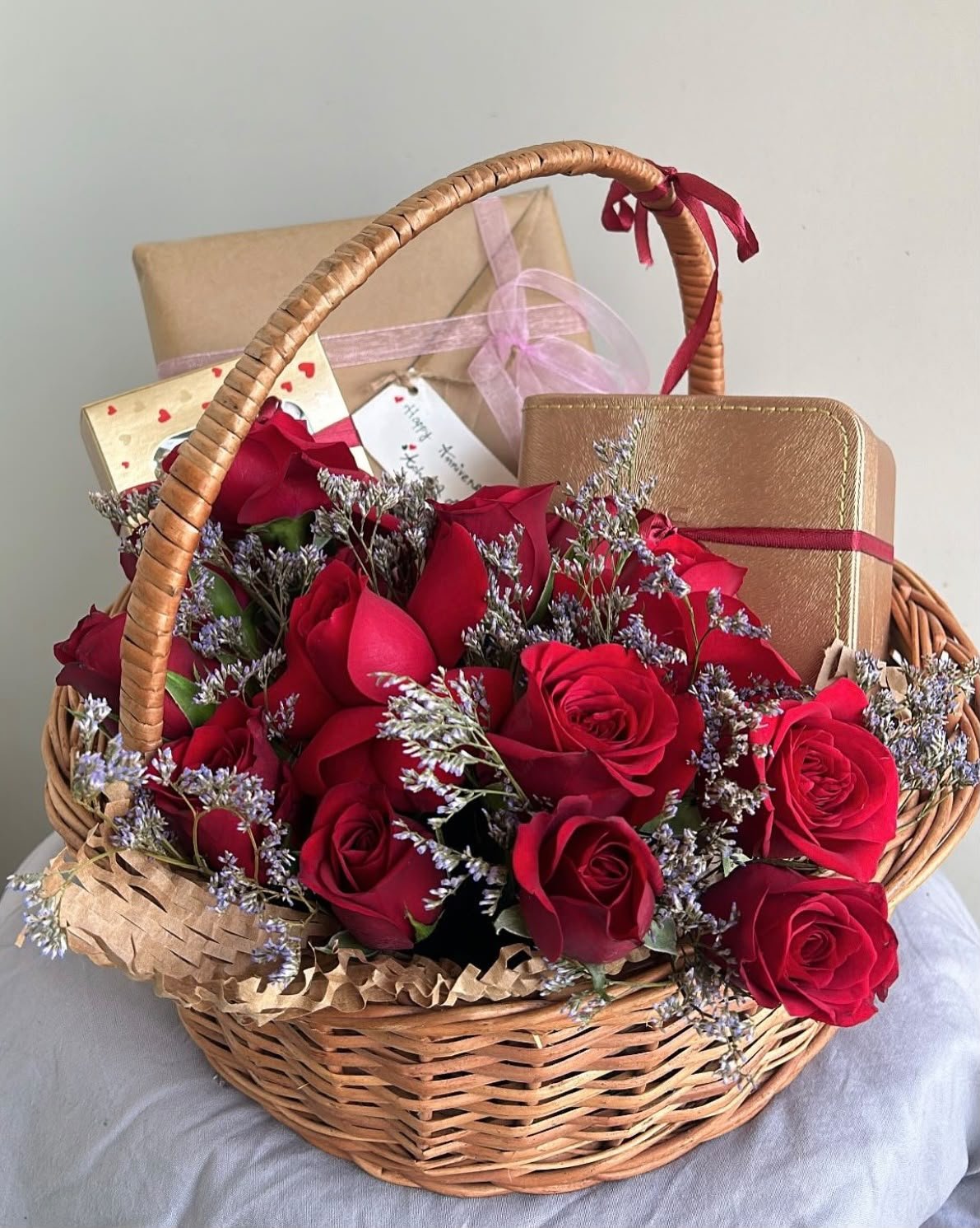 Premium floral arrangement in Calicut — red roses in a wicker gift basket by CHLORIS