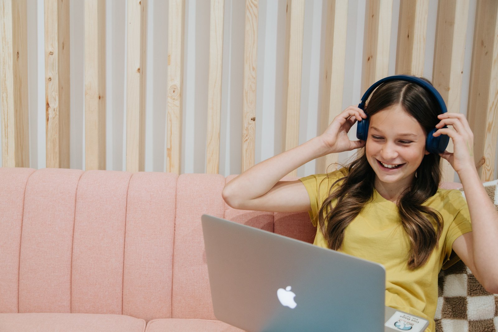 Student listening to a podcast on a laptop