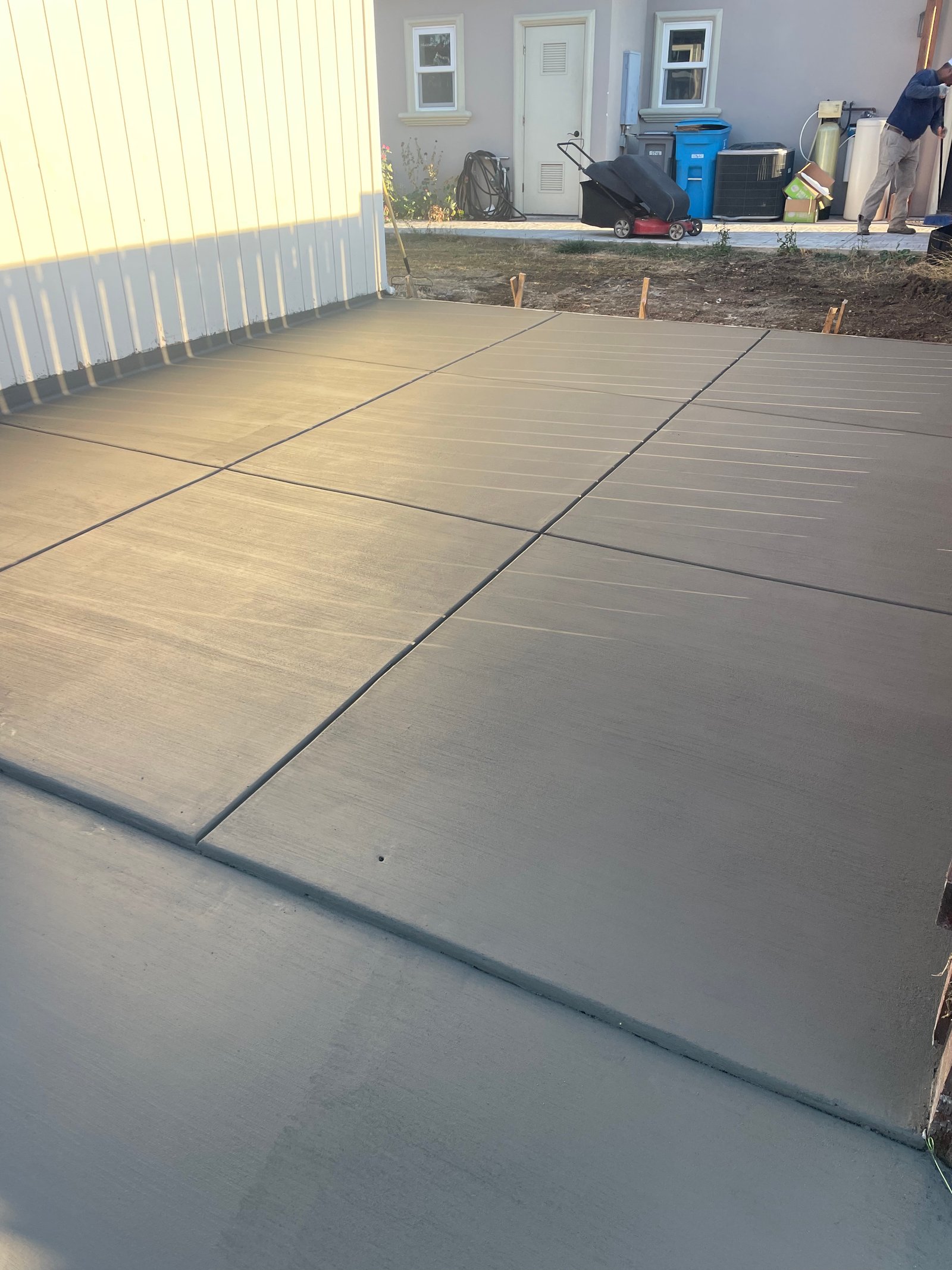 Finished concrete driveway with light tan/beige color and control joints
