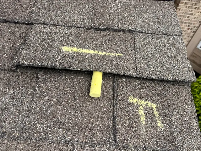 Chalk marks showing a wind-lifted, unsealed shingle tab on a Dayton, Ohio roof