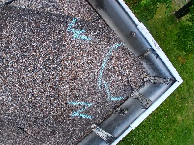Chalk-marked hail damage beside a dented gutter corner on a Cincinnati, Ohio roof