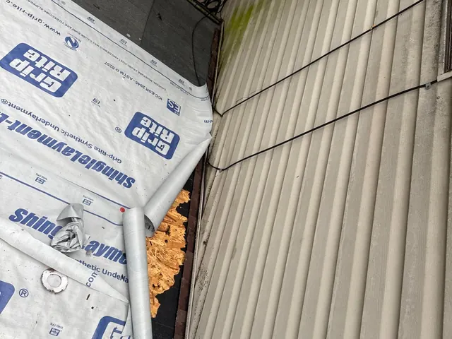 Synthetic underlayment installed along a roof-to-wall transition during a Cincinnati, Ohio roof replacement