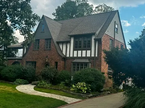 Brick Tudor home in Oakwood, Ohio with a new GAF Timberline HDZ roof in Weathered Wood installed by XPRO ELITE