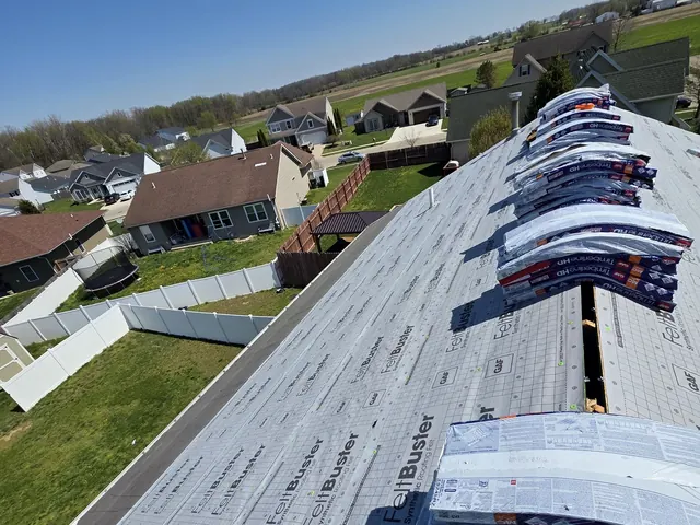 GAF FeltBuster synthetic underlayment installed and shingle bundles staged on a roof in New Carlisle, Ohio