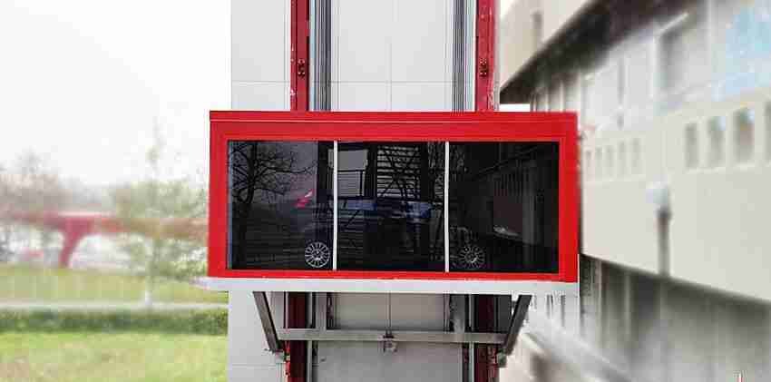 PARKPIÙ car lift with red and white structure