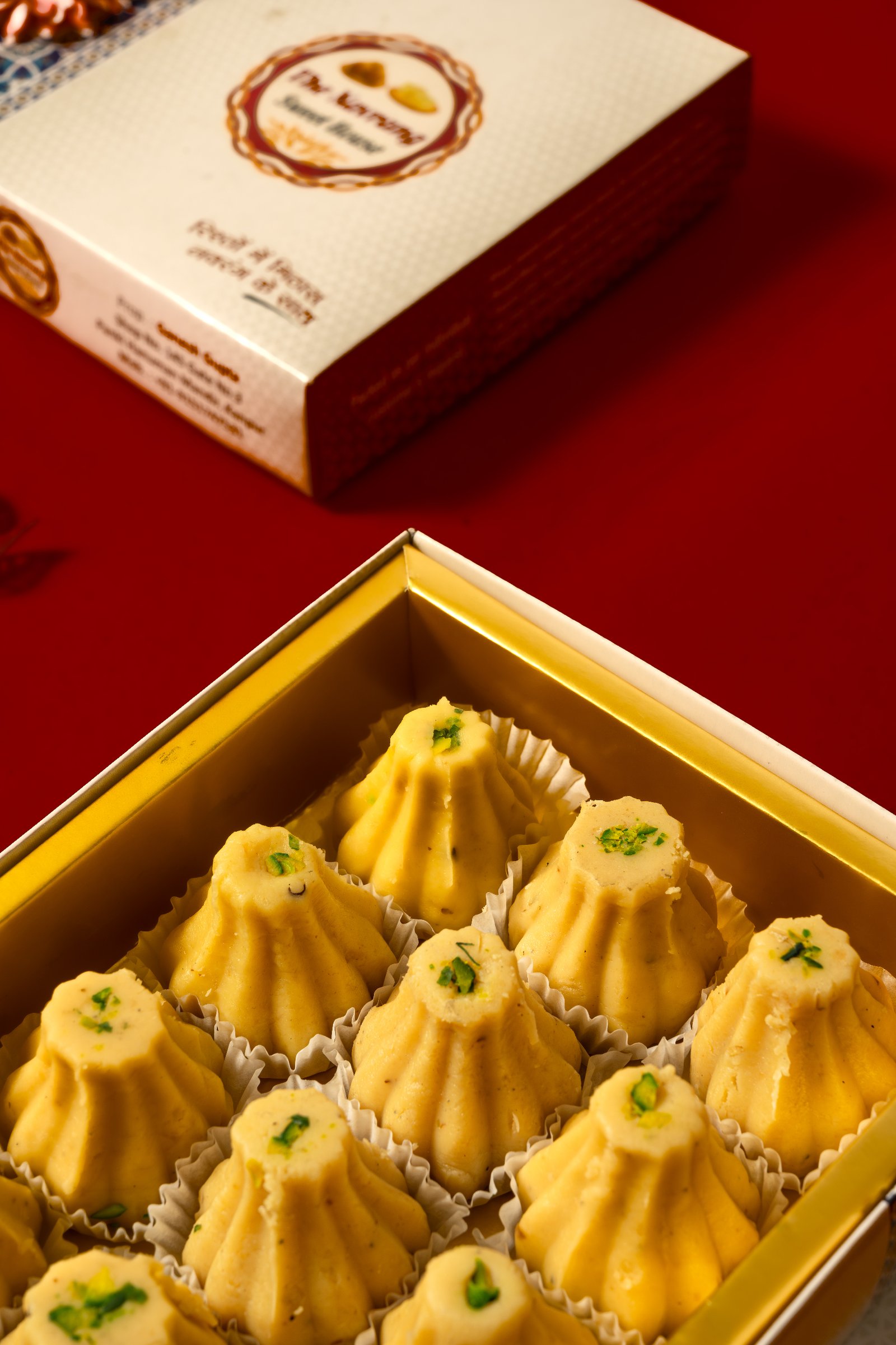Assorted fresh Indian sweets including laddus, barfis, and pedas at The Navrang Sweet House, Kanpur