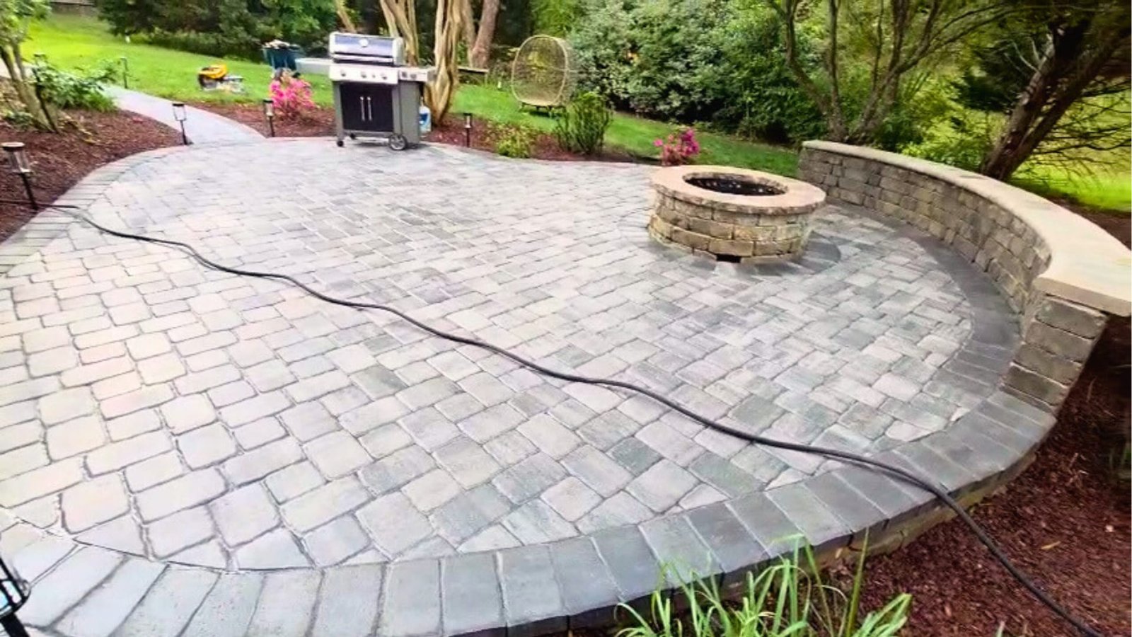 Finished patio with stone walls and entertainment space