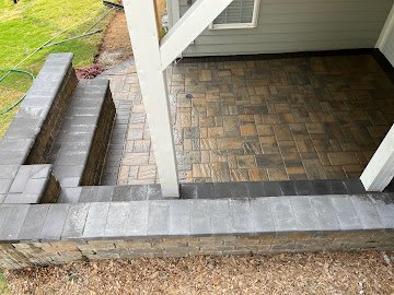 Herringbone patio with paver steps by the deck