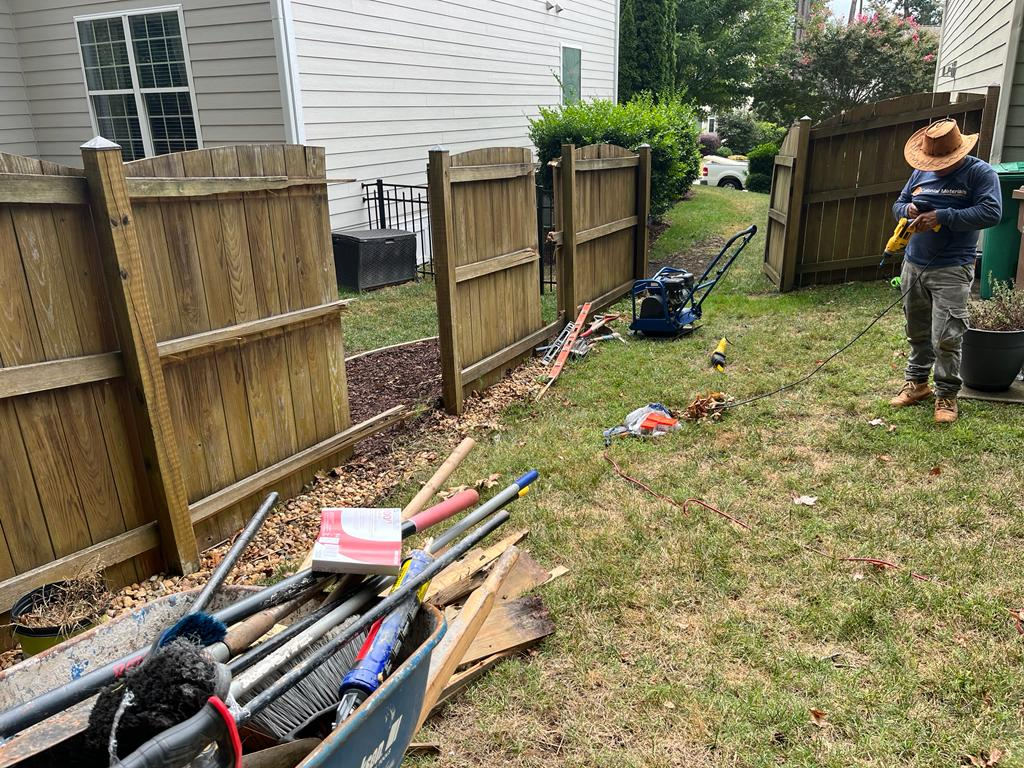 Fence installation crew setting posts