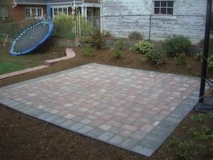 Square paver patio near trampoline & garden beds