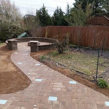 Stone patio with curved walkway and fire pit