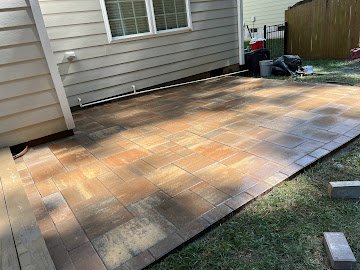 Large patio installed behind home exterior