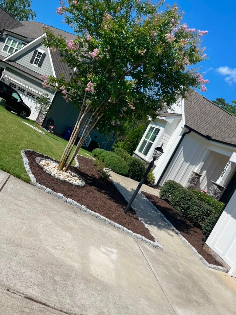 Landscaping with fresh mulch installation
