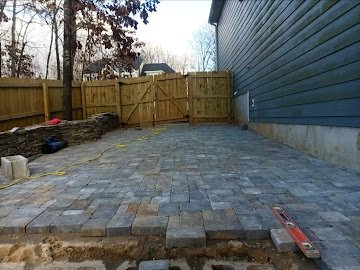Paver patio with wood fence & gate backdrop