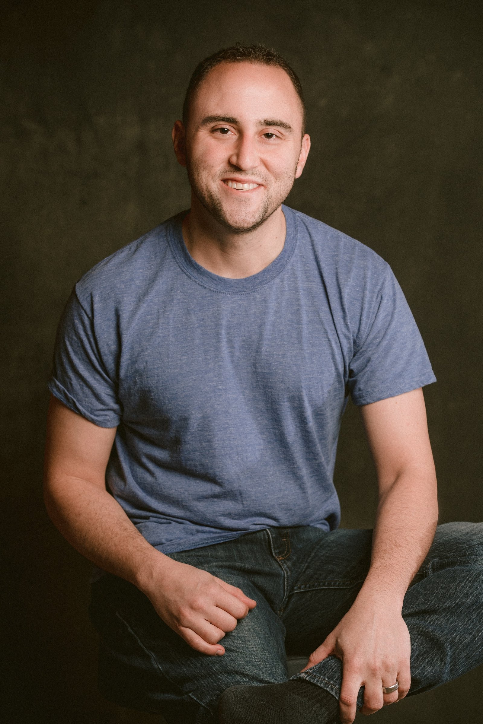 Adam Joseph Turner seated portrait in a blue t-shirt