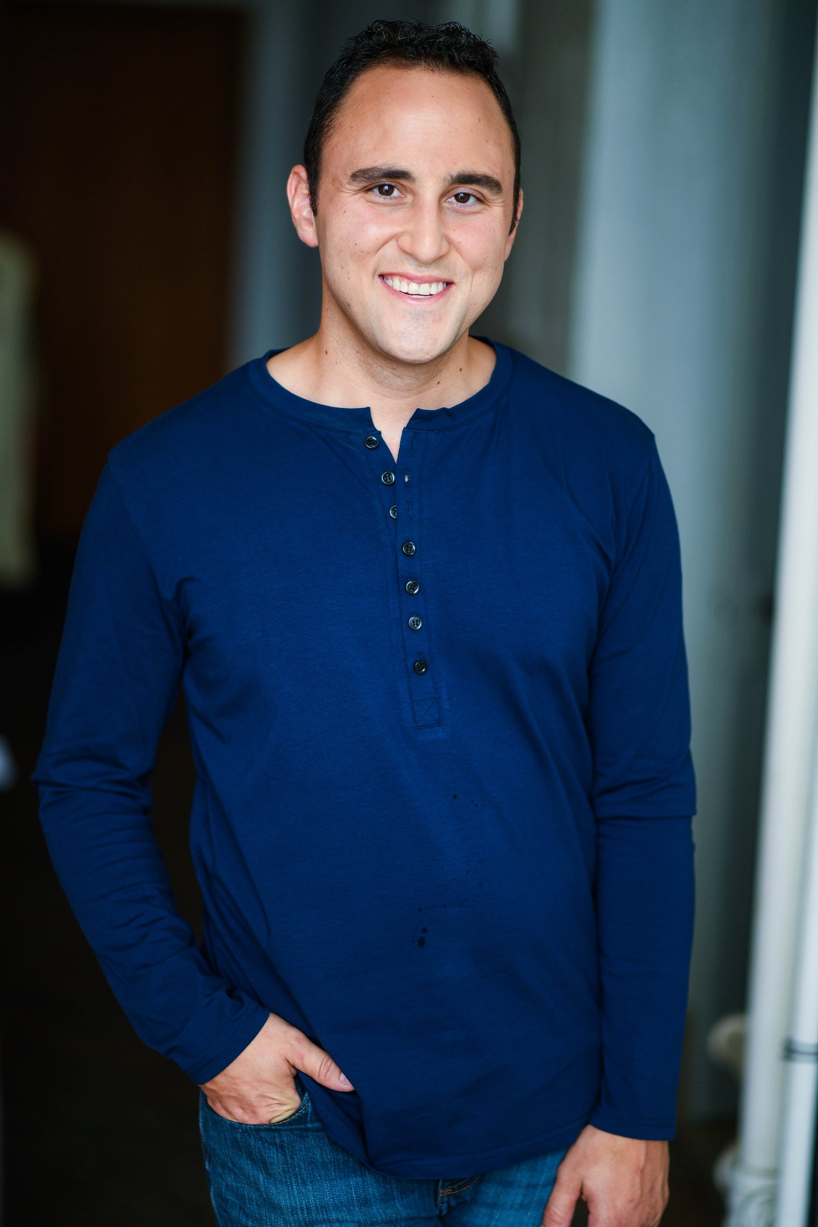 Adam Joseph Turner standing portrait in a blue henley