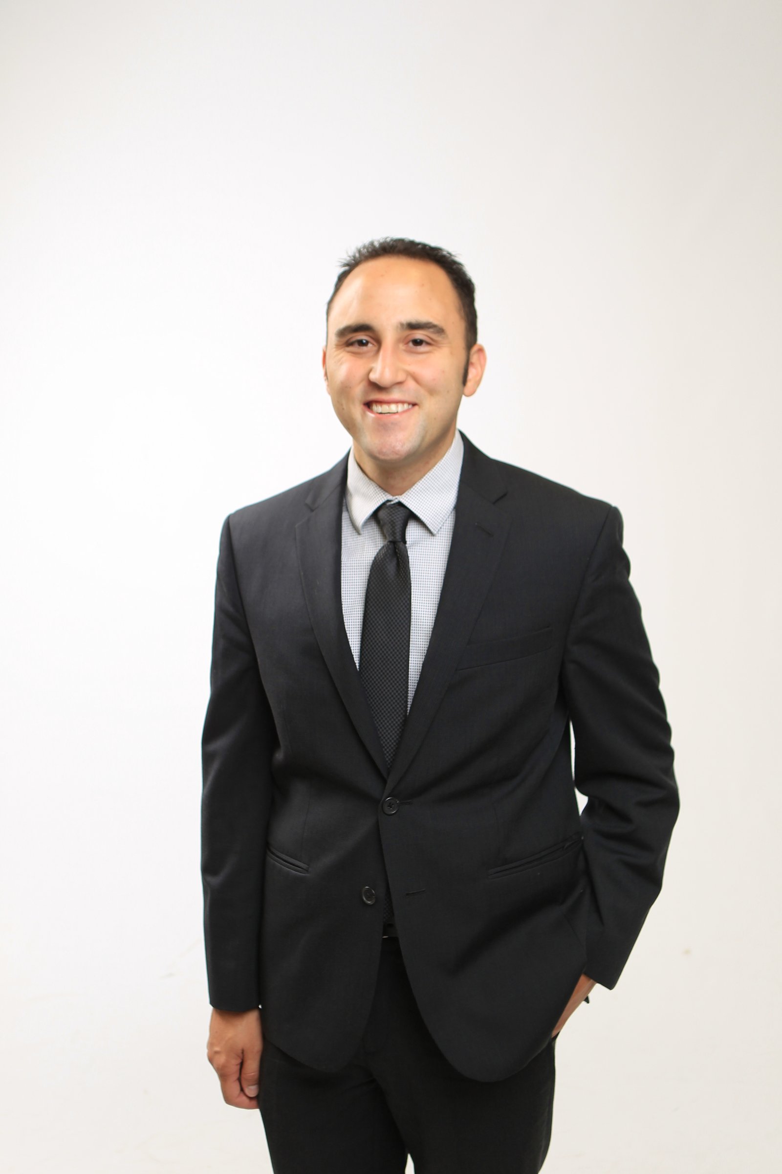Adam Joseph Turner formal studio portrait in a dark suit and tie