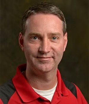 Professional headshot of Dr. Jason Chesnut, a man with short brown hair and a red polo shirt.