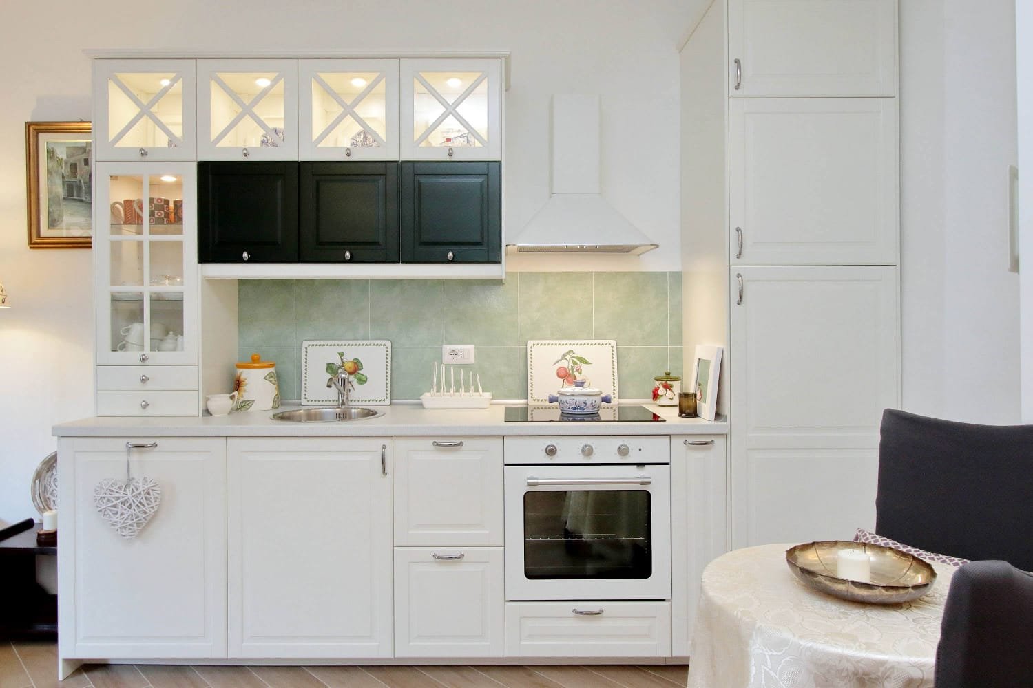Bathroom with teal and green tiles, white fixtures