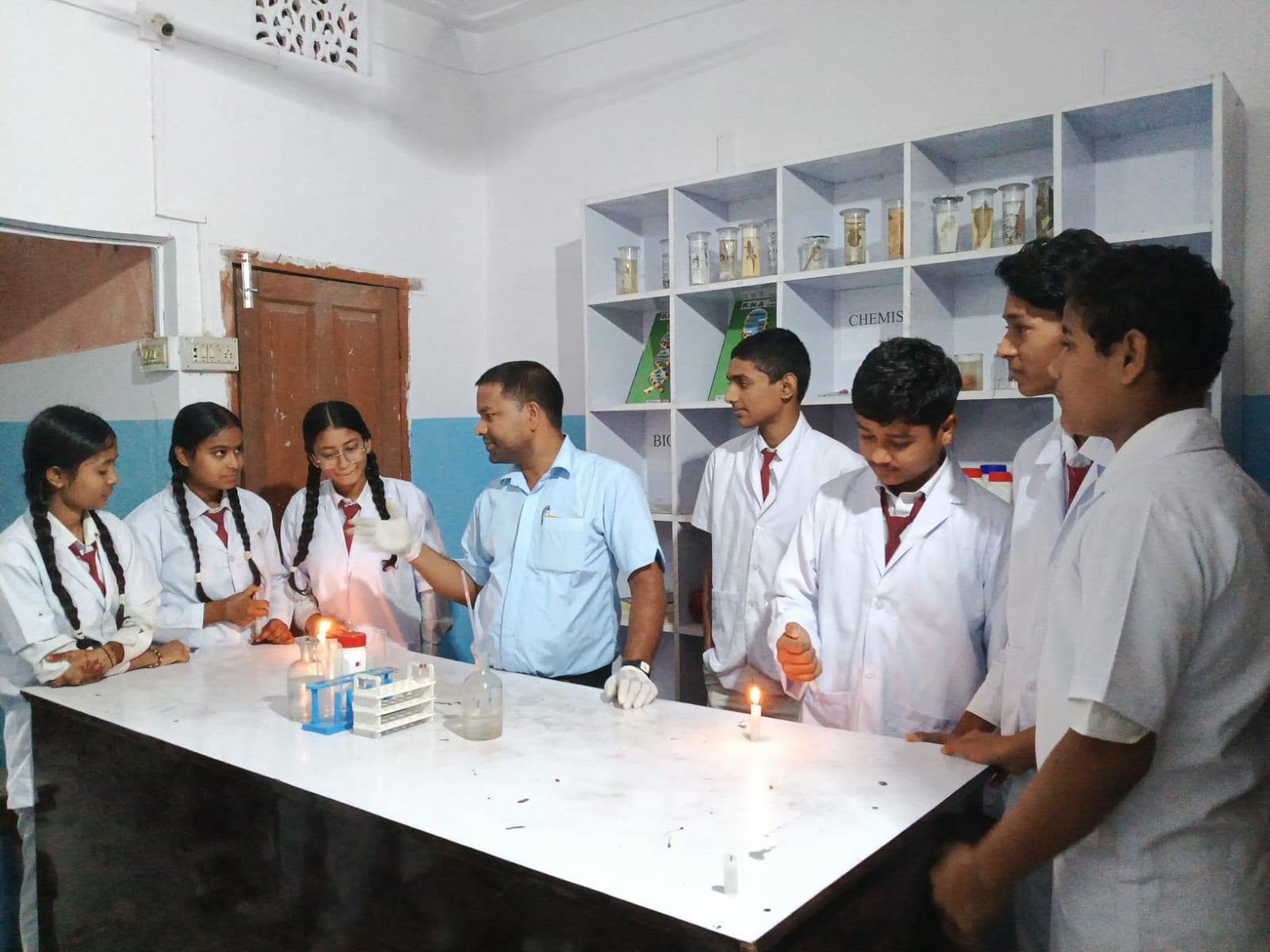 Secondary students conducting a chemistry experiment in the Himali science laboratory