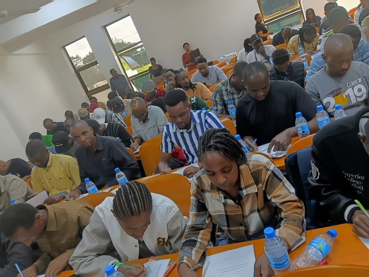 First-aid course participants completing written activities in a classroom.