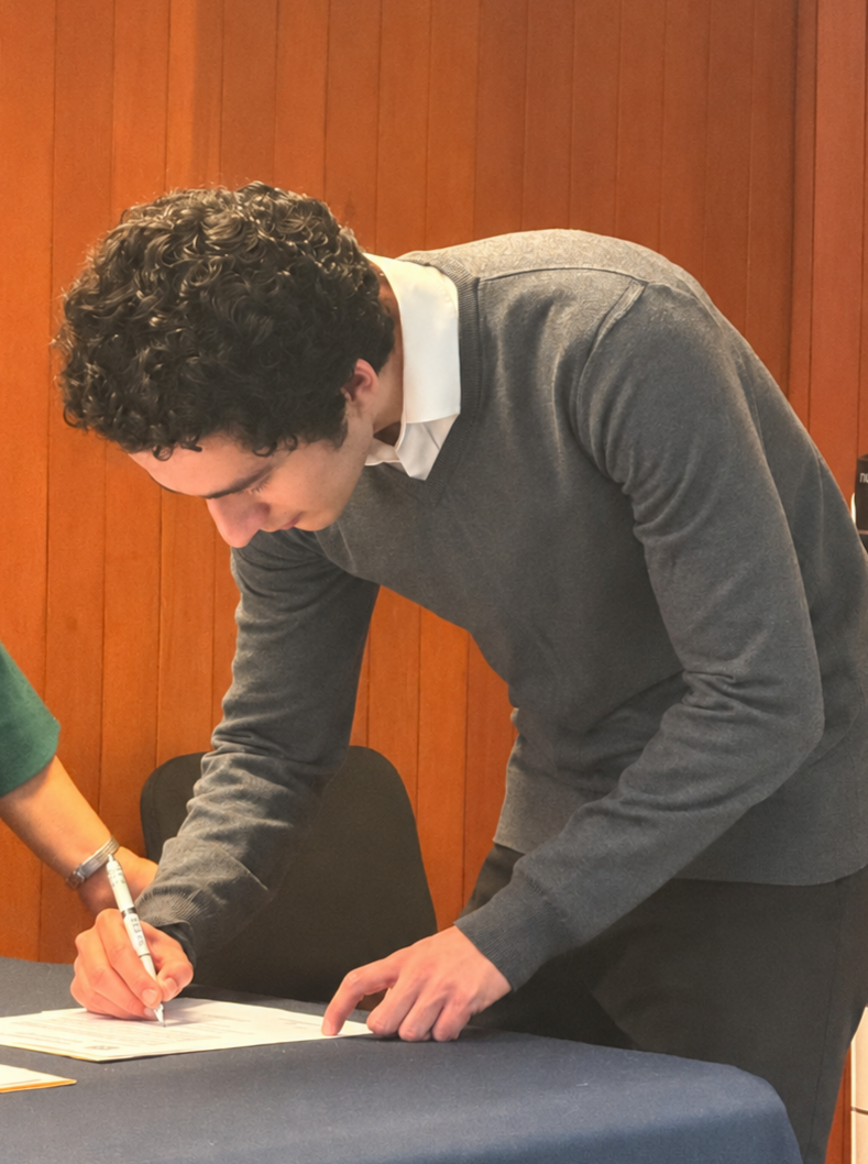 Emiliano Aguirre-Pimienta writing at a desk