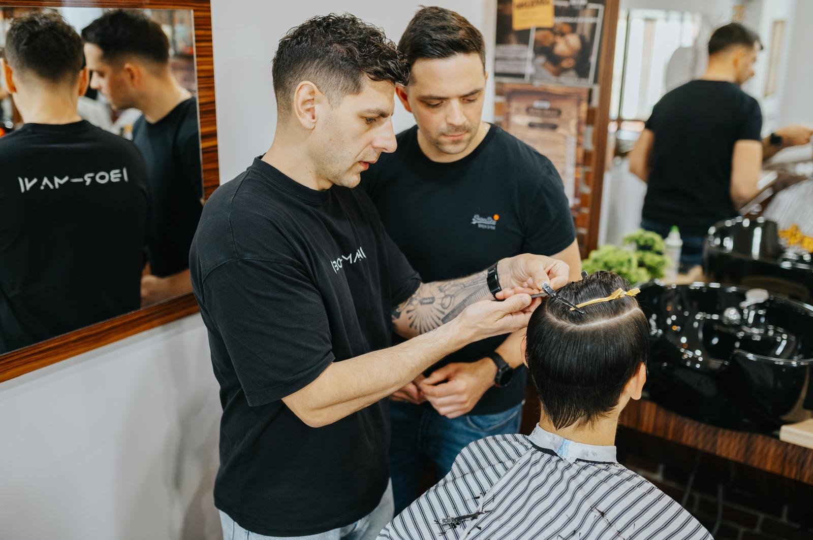 Two students practicing barbering