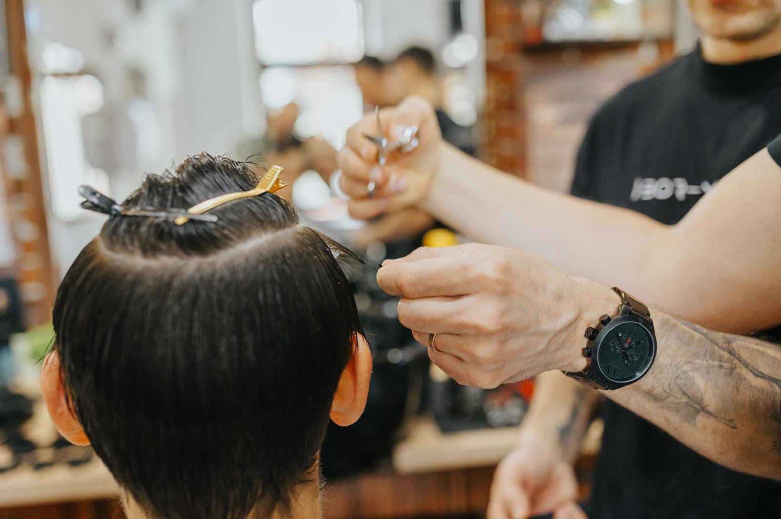 Close-up of barber cutting hair
