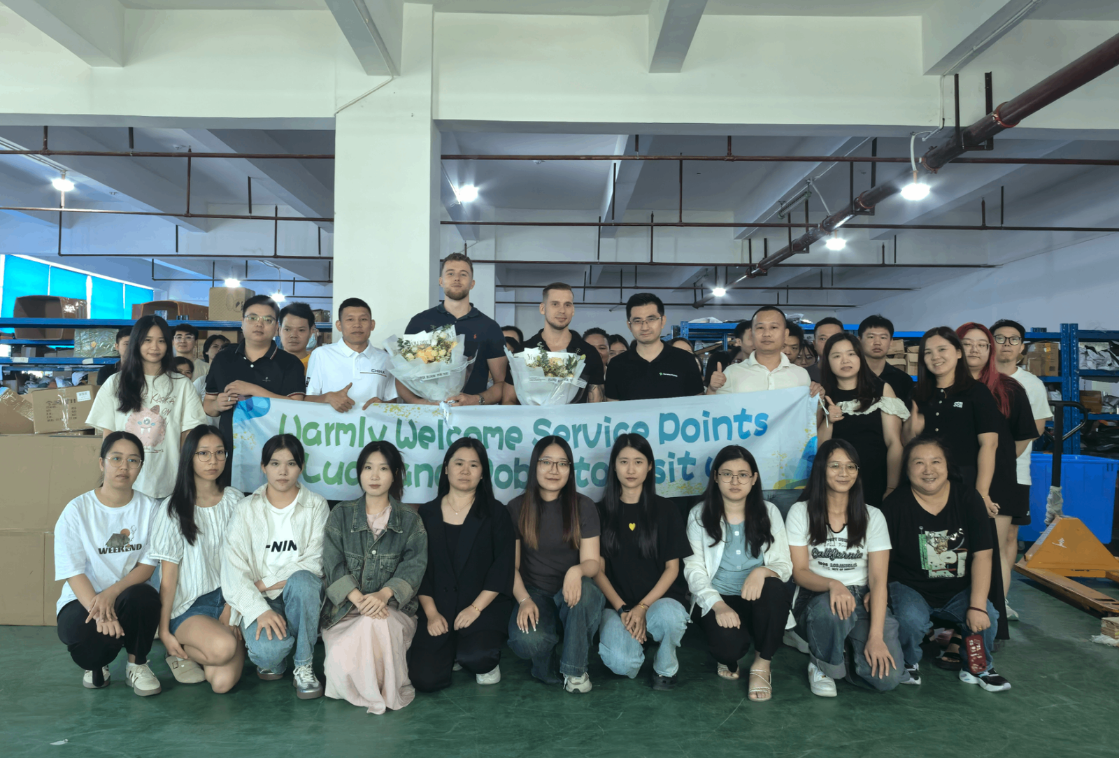 Large group photo with Service Points team visiting our facility