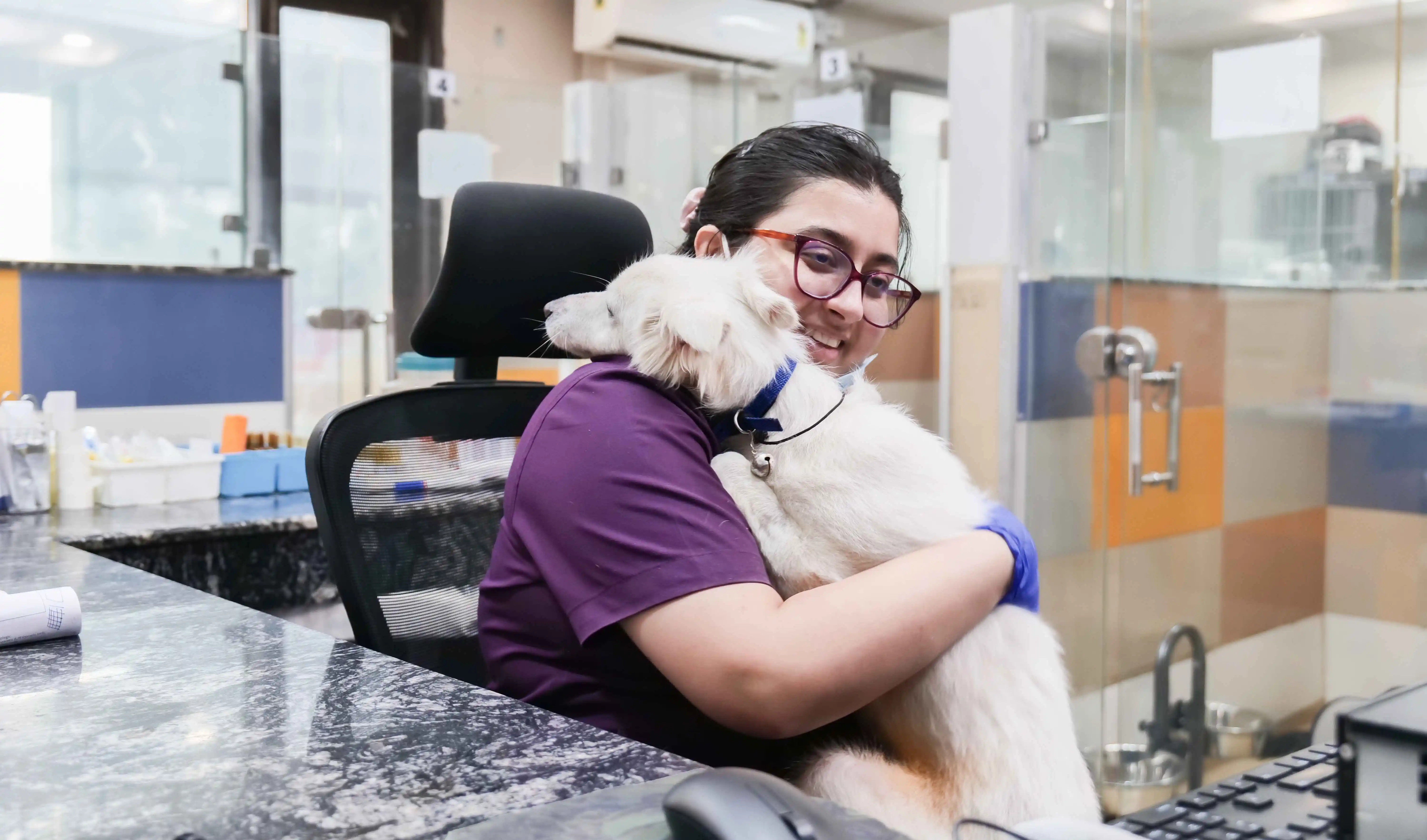 Veterinarian hugging a dog at MaxPetZ hospital