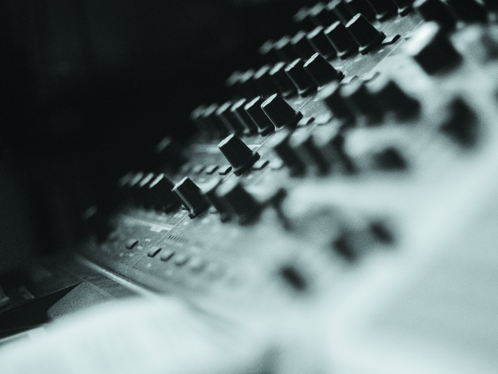 Close-up of a piano keyboard in a dark studio