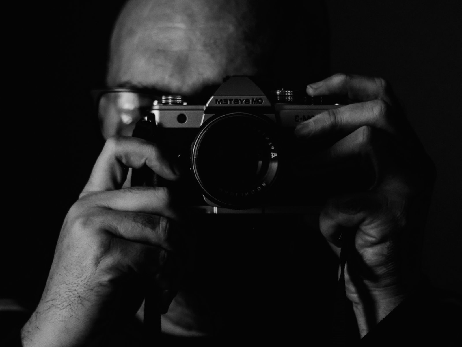 Fred holding a camera to his face