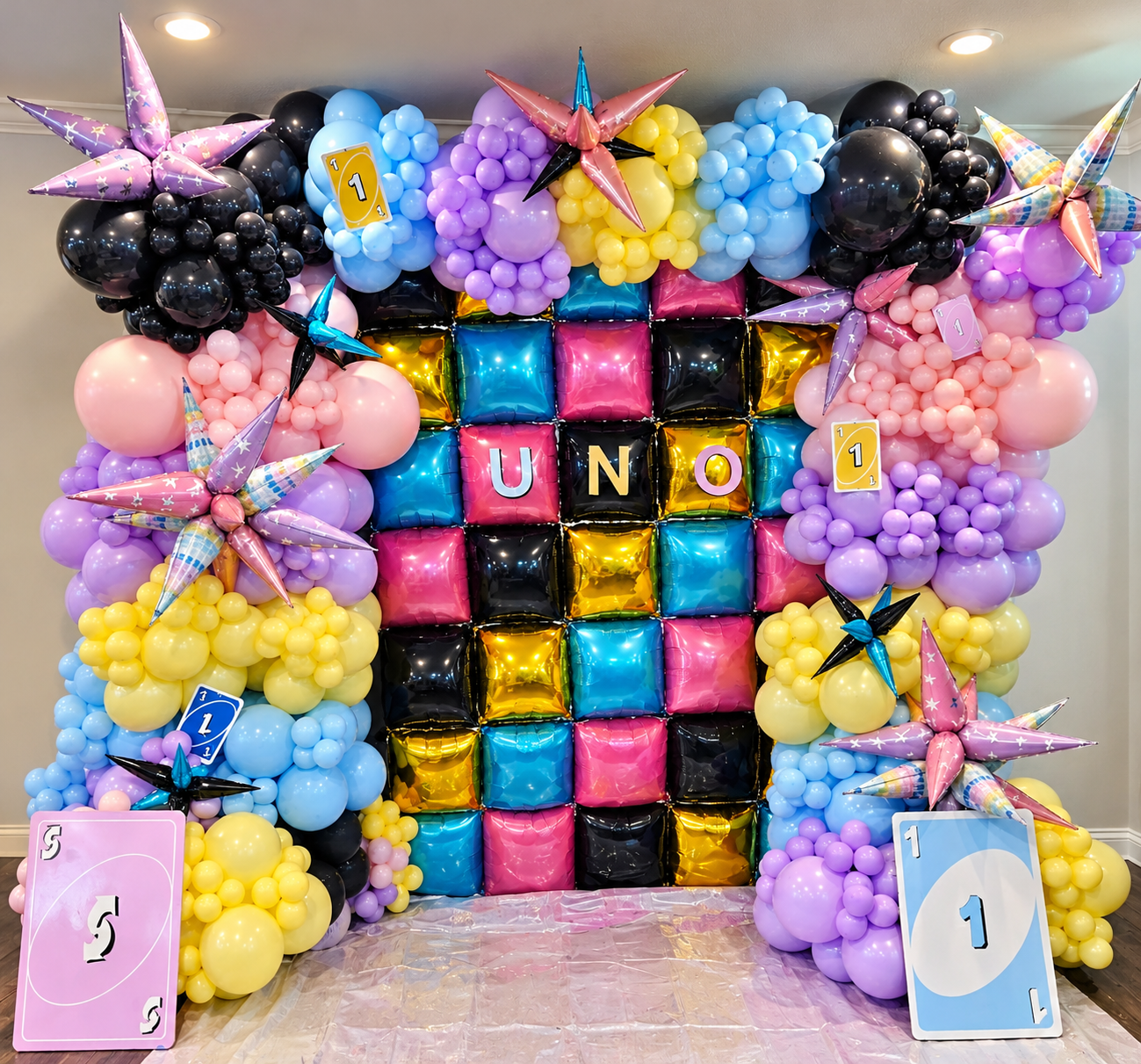 Colorful UNO-themed balloon wall with cube foil balloons by Joiful Expressions