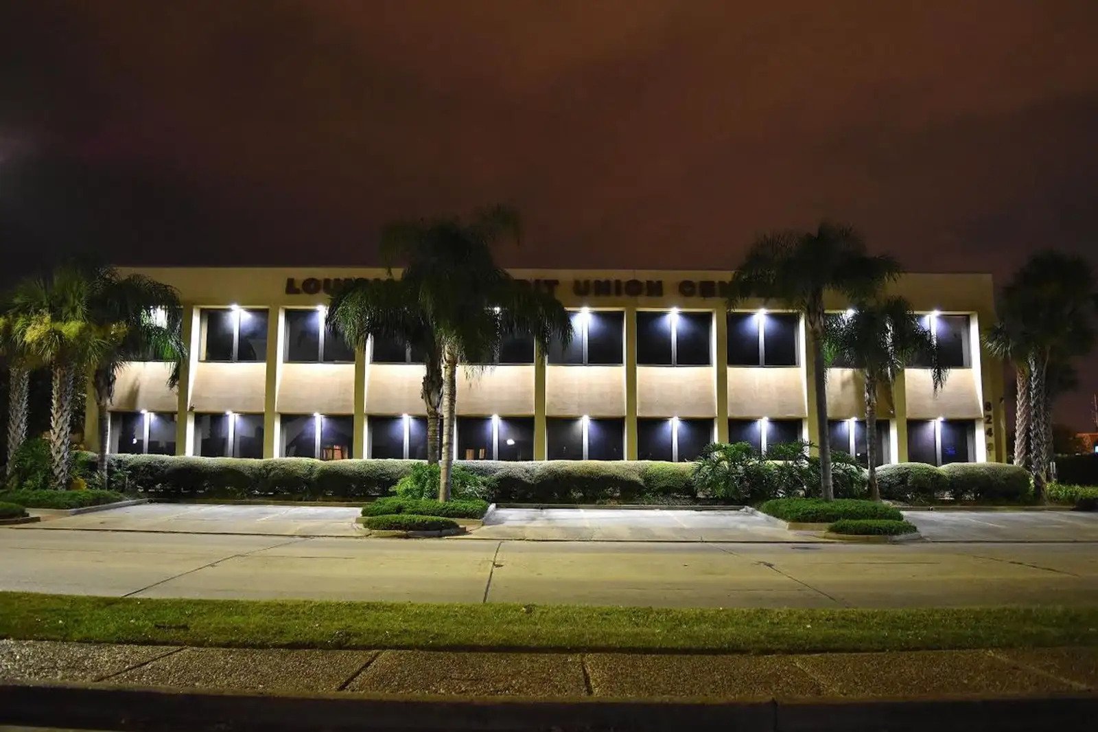 Professional office building exterior at night with illuminated windows