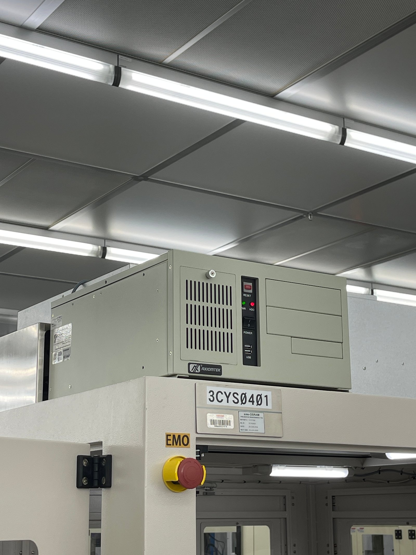 Machine vision inspection station with an industrial camera inspecting printed circuit boards on a conveyor in a Malaysian semiconductor factory