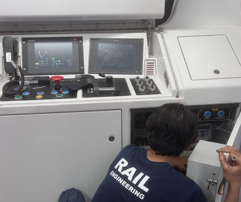 Railway-certified rugged touchscreen panel PC inside a modern train driver's cab in Kuala Lumpur, Malaysia
