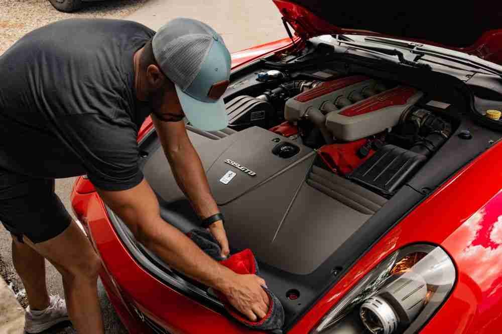 Precision engine bay detailing on a red Ferrari