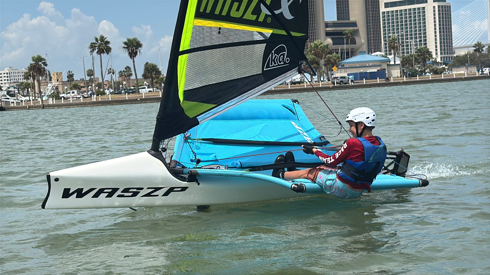 USFoil coach sailing a WASZP foiling dinghy on the water