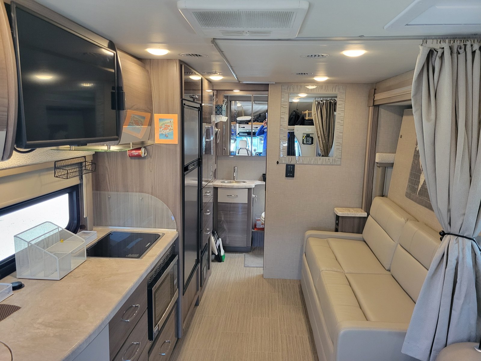 RV interior showing kitchen, living area with modern furnishings and ...