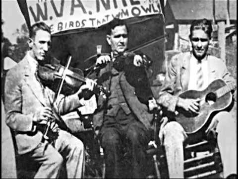 Blind Alfred Reed performing with band members, vintage historical photograph