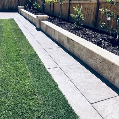 Concrete retaining wall with artificial turf and landscaping