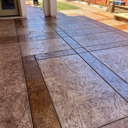Concrete patio with geometric pattern and landscaping