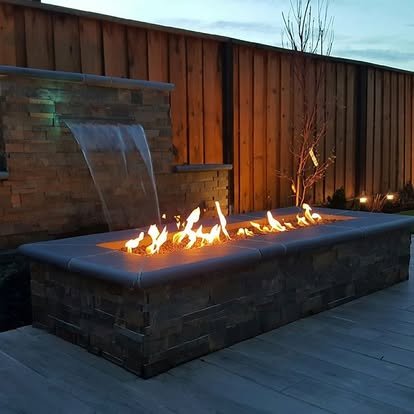 Modern fire pit with water feature and wooden fence