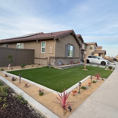 Modern home with concrete driveway and artificial turf landscaping