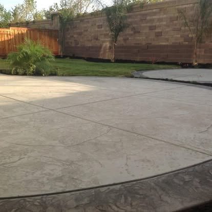 Concrete patio adjoining a lush garden